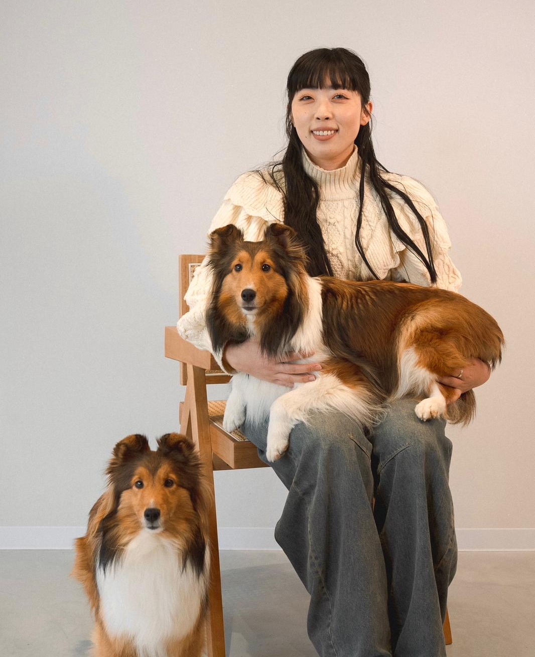Misaki, the groomer, holding one of her Shetland Sheepdogs